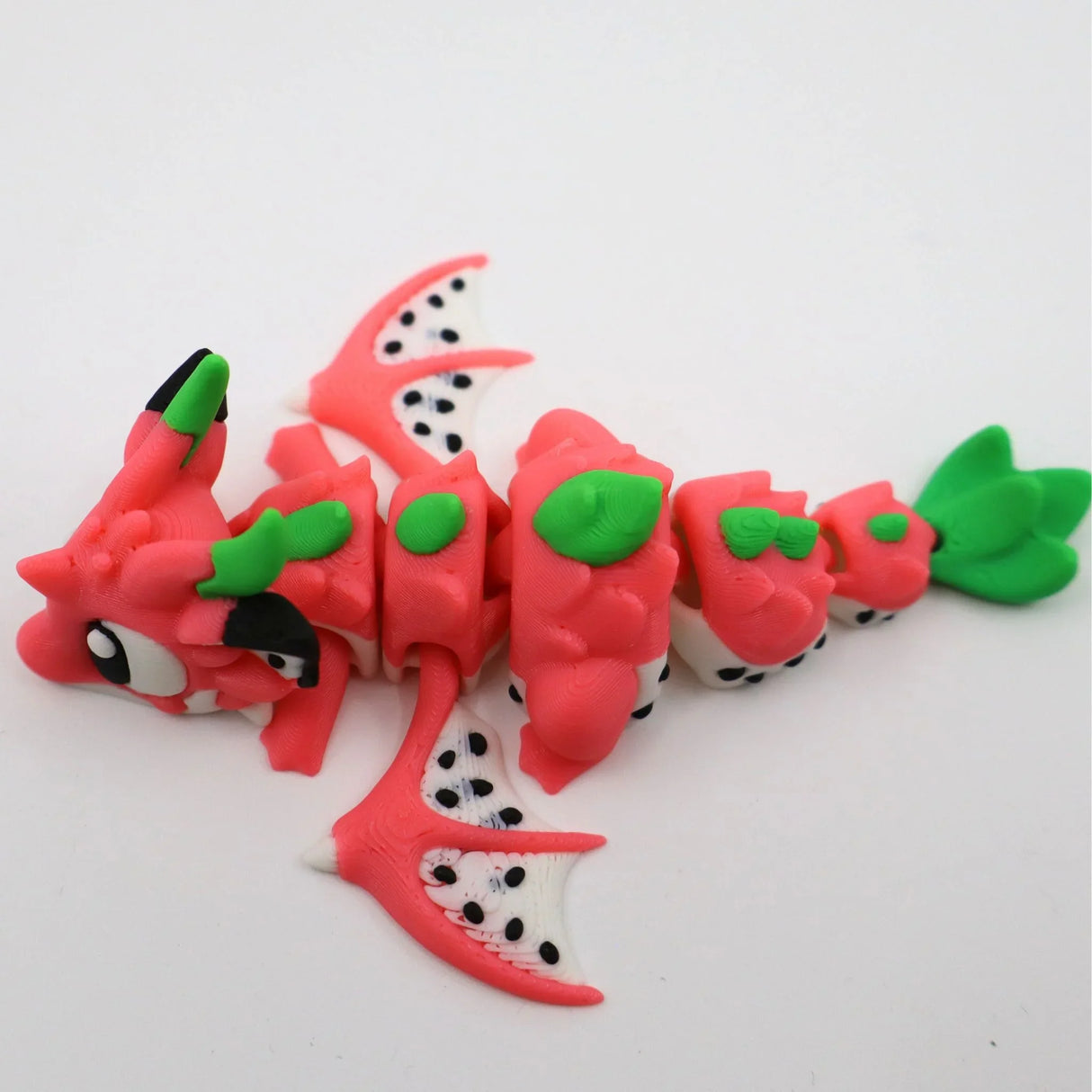 Colorful 3D printed dragon fruit fidget toy with movable segments and green leaf accents