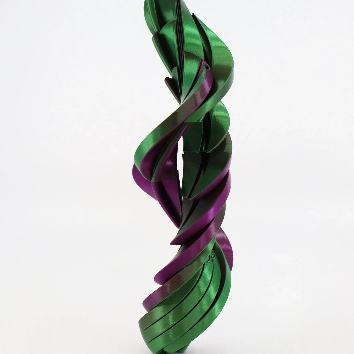 Green and purple 3D printed sensory fidget toy with spiral, twisting design