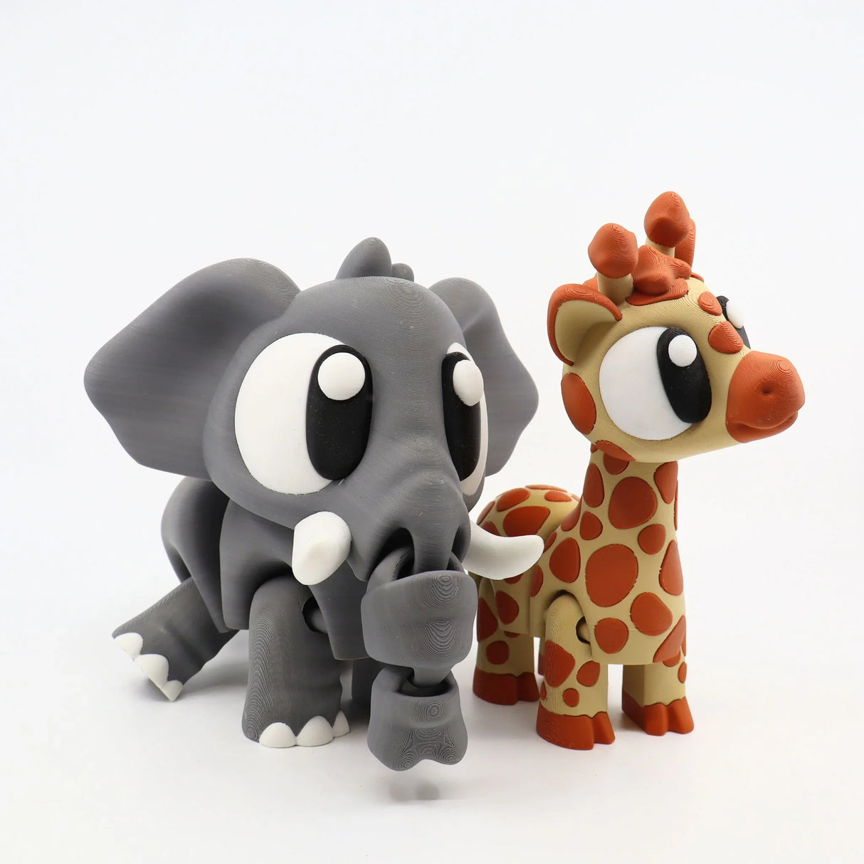 3D printed sensory toy elephant and giraffe with large eyes on white background