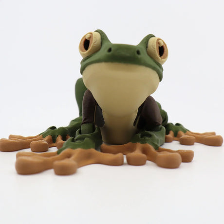 3D printed sensory frog toy with green body and light brown feet on white background