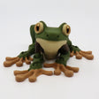 3D printed green and brown frog sensory toy with big eyes on a white background.