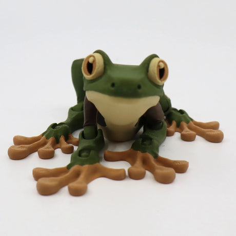 3D printed green and brown frog sensory toy with big eyes on a white background.