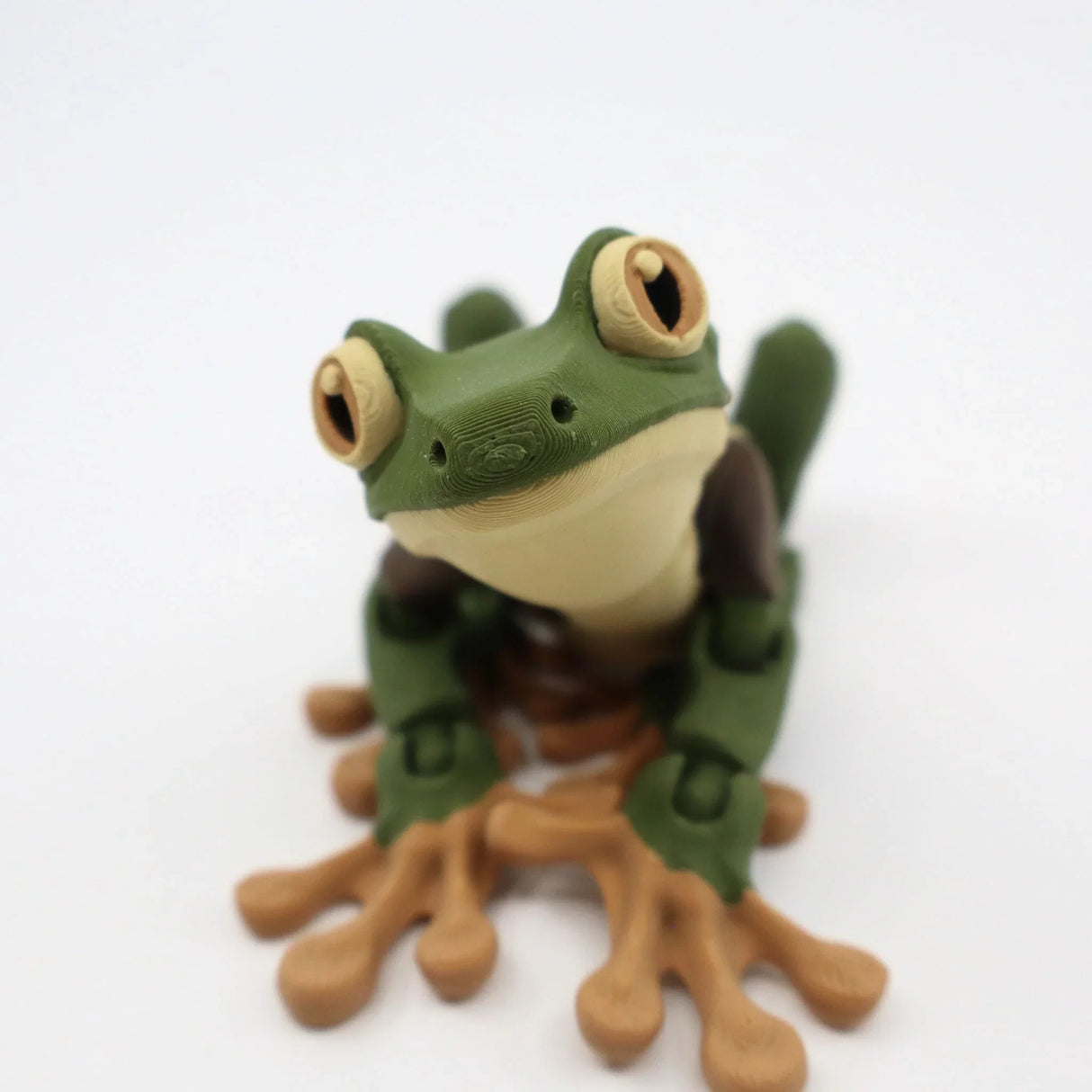 3D printed green frog sensory toy with jointed limbs on white background