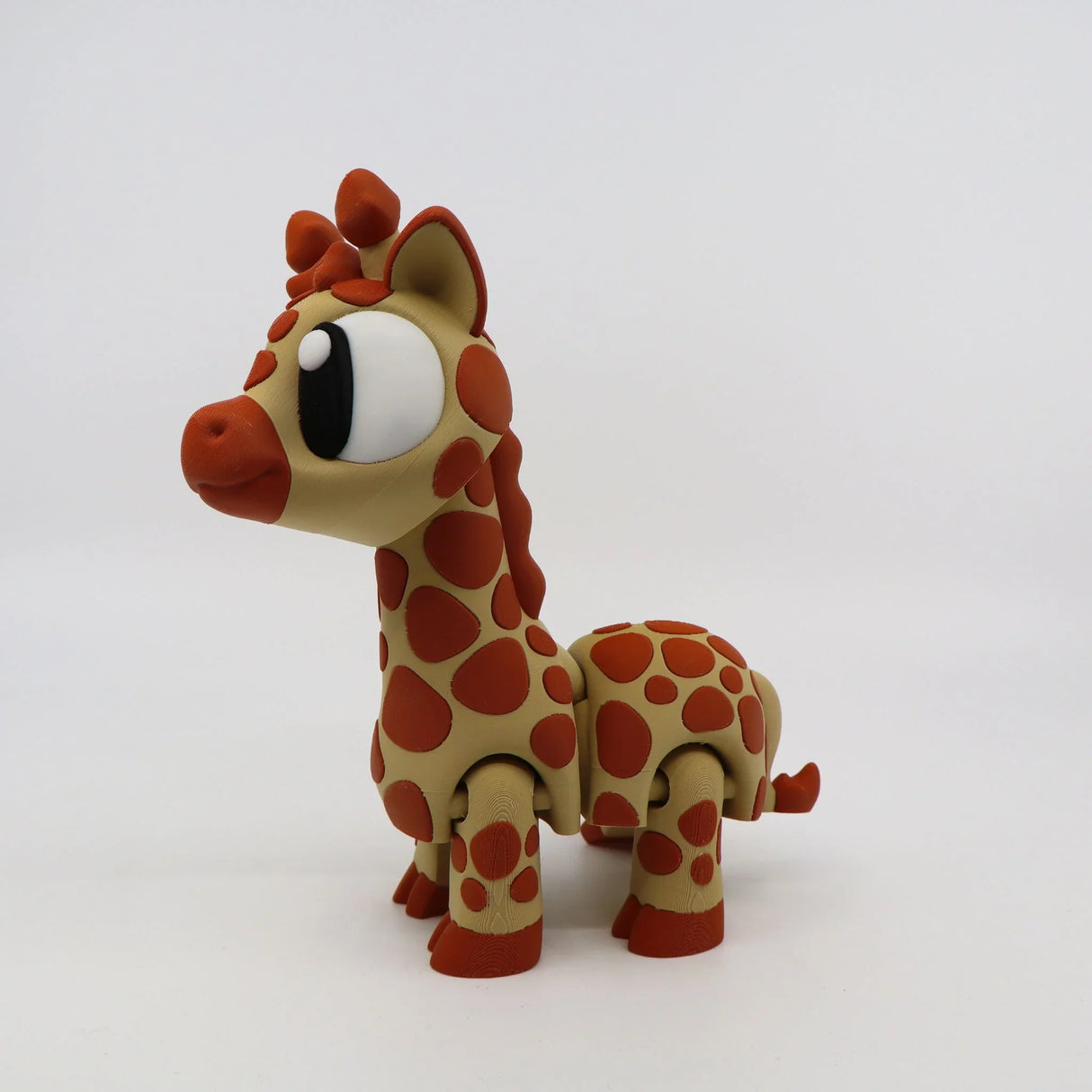 Cute 3D printed giraffe sensory toy with orange spots, jointed legs, and big eyes on white background