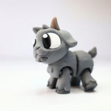 Gray 3D printed goat figurine sensory toy with big eyes on white background