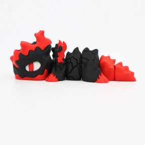 3D printed sensory toy shaped like a black and red dragon with segmented body and large eye