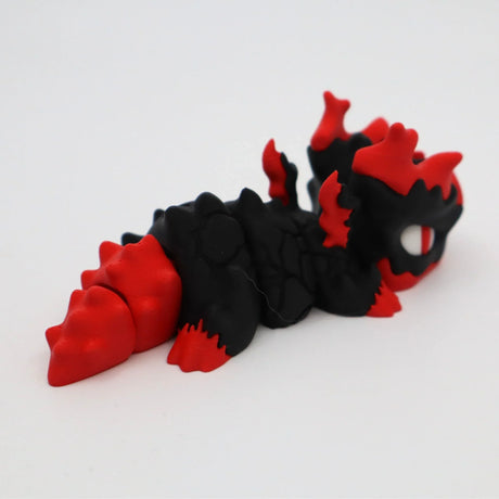 Black and red 3D printed sensory dragon toy with textured body on white background