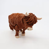 3D printed brown highland cow sensory toy with textured fur on white background