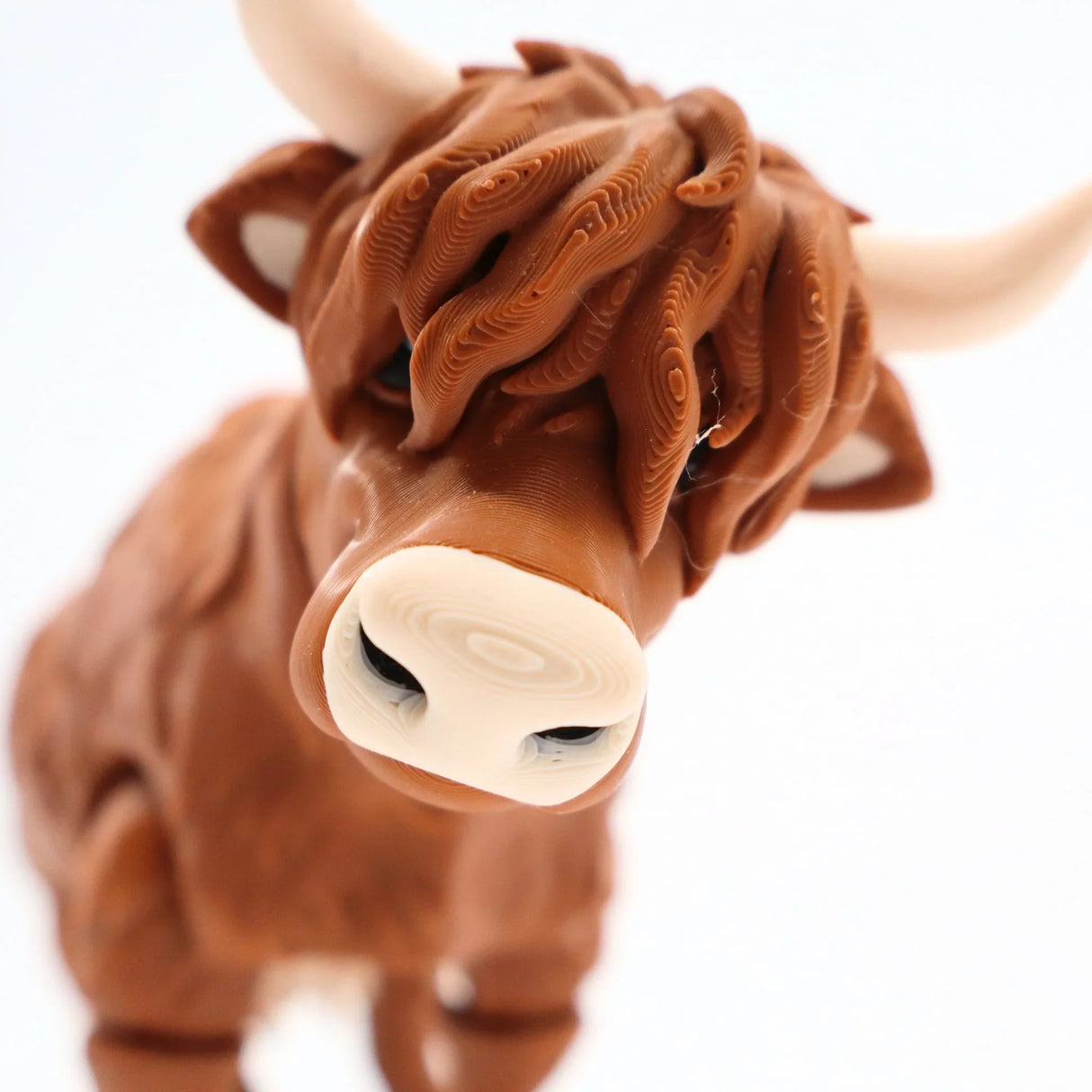 3D printed Highland cow sensory toy with textured brown fur and white horns