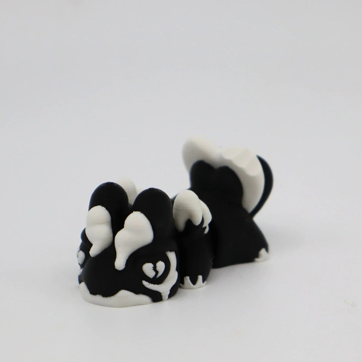 3D printed black and white skunk fidget toy for sensory play and stress relief