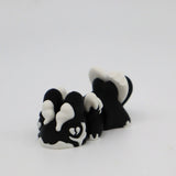 3D printed black and white skunk fidget toy for sensory play and stress relief