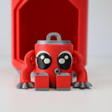 Cute red 3D printed sensory toy with big eyes and silver claws on white background