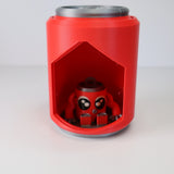 Red 3D printed sensory toy shaped like a can with a cute octopus figure inside