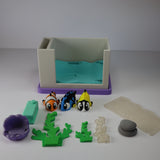 3D printed sensory aquarium playset with colorful toy fish, plants, and tank accessories