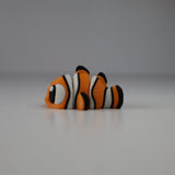 3D printed orange and white clownfish sensory toy on a plain white background