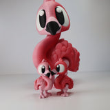 3D printed pink flamingo sensory toys, one large and two small, on white background
