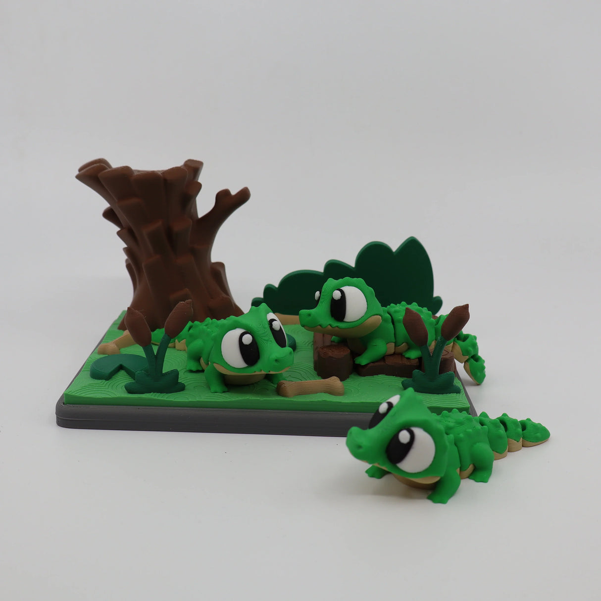 3D printed green alligator fidget toys with tree stump and marsh setting for sensory play