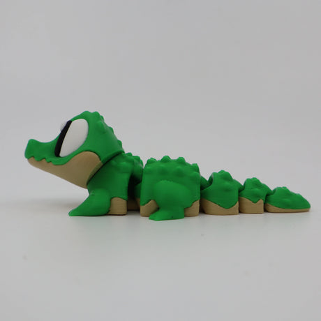 Green 3D printed crocodile fidget toy with segmented body for sensory play