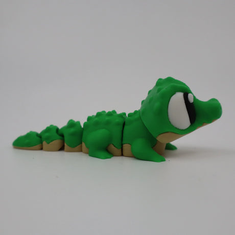 Green 3D printed alligator fidget toy with textured segments for sensory play
