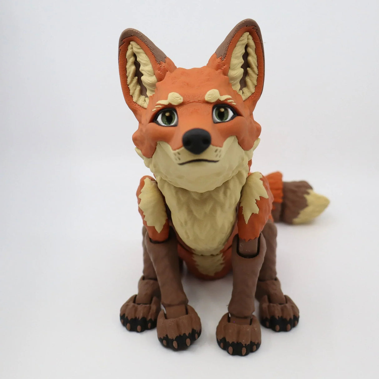 3D printed articulated fox sensory toy with orange fur, sitting on a white background