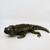 3D printed green lizard sensory toy with jointed body on white background