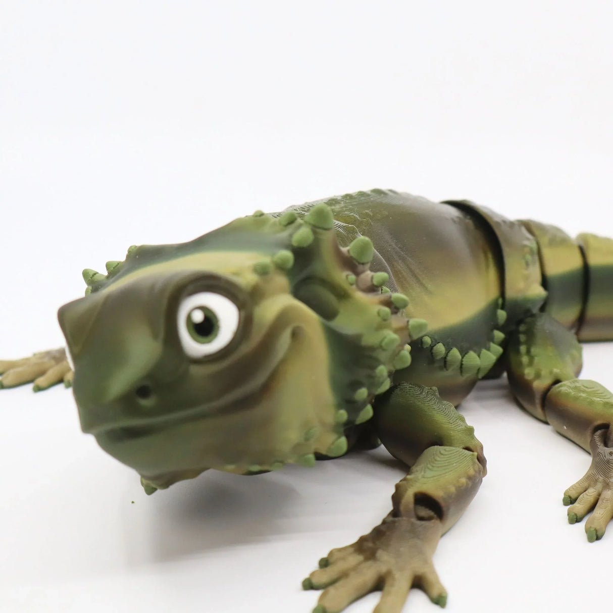 3D printed sensory toy lizard with green scales and jointed limbs on white background
