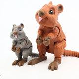Two colorful 3D printed quokka sensory toys with movable joints on a white background.