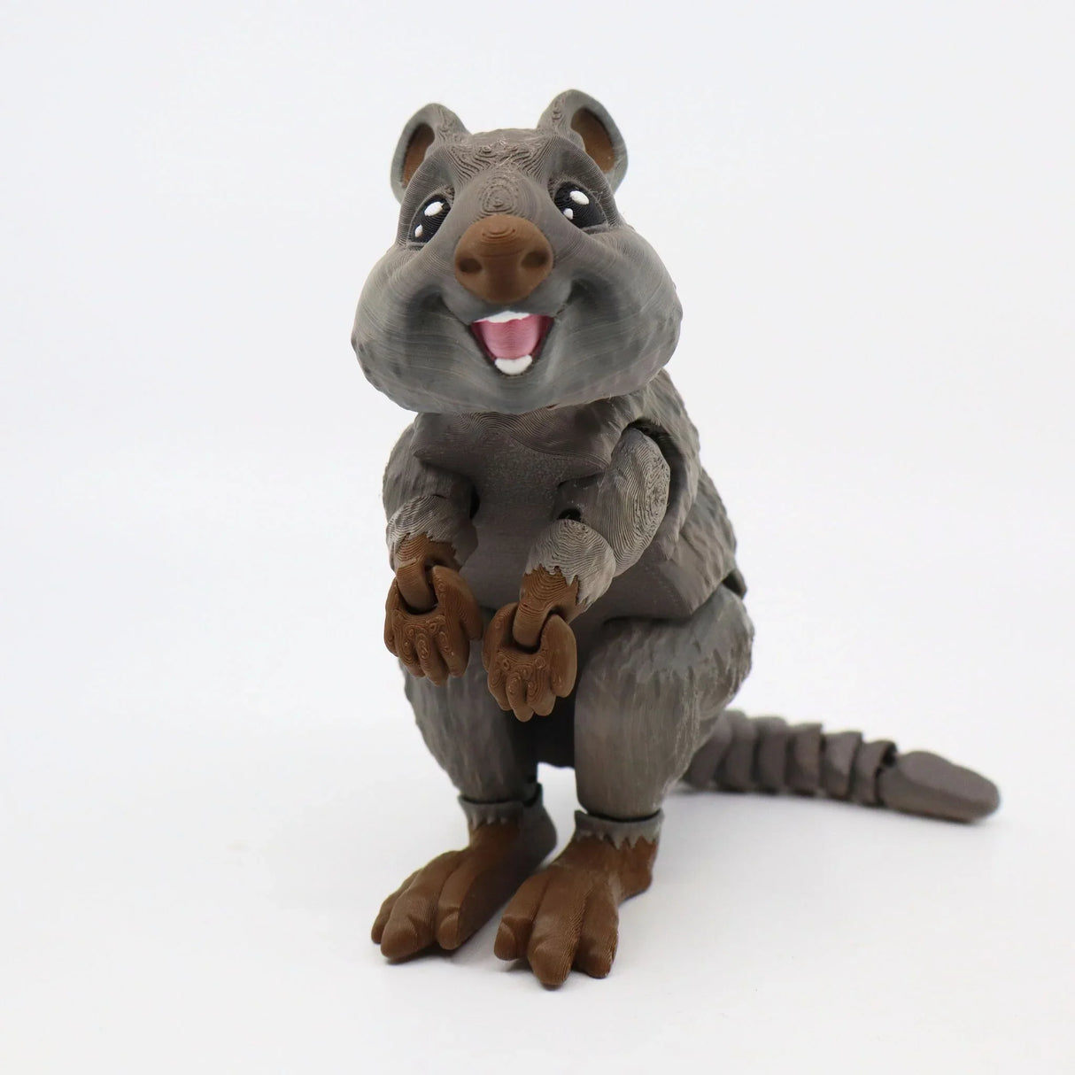 3D printed brown quokka sensory toy with articulated limbs and smiling face on white background.
