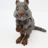 3D printed sensory toy quokka with moveable limbs, textured gray fur, and cute smiling face