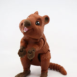 Smiling 3D printed brown quokka sensory toy with movable limbs on white background