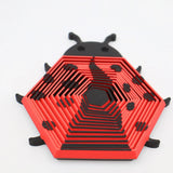 3D printed red and black ladybug-shaped sensory toy with hexagonal, stackable layers