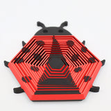 Red and black hexagonal ladybug-shaped 3D printed sensory fidget toy on white background