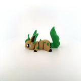 3D printed sensory toy of a cute green and tan animal with jointed segments