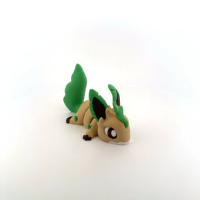 3D printed sensory toy of a cute green and brown animal with leaf-shaped tail on white background