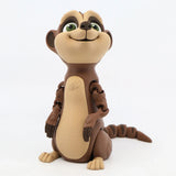3D printed brown meerkat sensory toy with articulated limbs and green eyes, on white background.