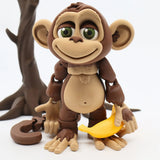 3D printed sensory monkey toy holding a yellow banana, standing in front of a tree