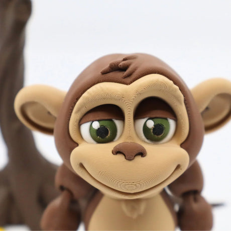 3D printed sensory monkey toy with large green eyes and detailed textures