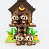 3D printed sensory toy of four cartoon monkeys with big eyes by a treehouse and bananas