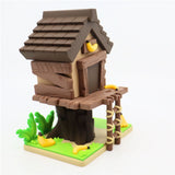 3D printed treehouse toy with brown roof, ladder, bananas, and green base for sensory play.