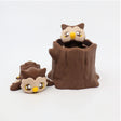 3D printed sensory owl toys, one in a tree stump and one lying beside, on a white background.