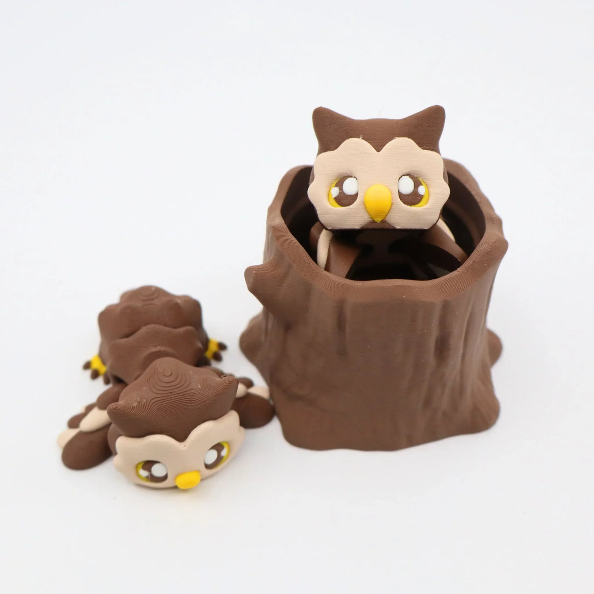 3D printed brown owl sensory toy set with owls and a tree stump on white background