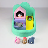 Colorful sensory toy playset with animal figurines, slide, and textured base