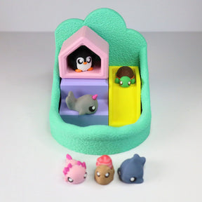 Colorful sensory toy playset with animal figurines, slide, and textured base