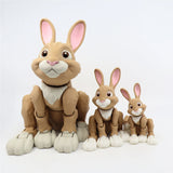 Set of three brown 3D printed sensory toy rabbits with articulated legs, white paws, and pink ears