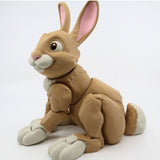 3D printed sensory toy rabbit with jointed limbs, tan and white color, on white background