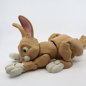 Flexible 3D printed rabbit sensory toy, tan with white paws, on plain white background