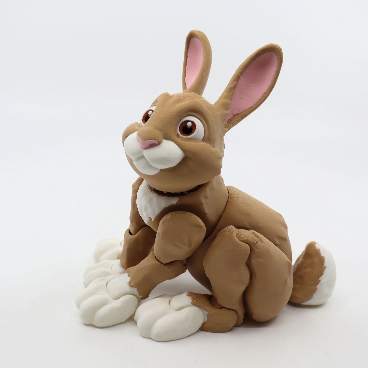3D printed brown rabbit sensory toy with white accents and large paws on white background