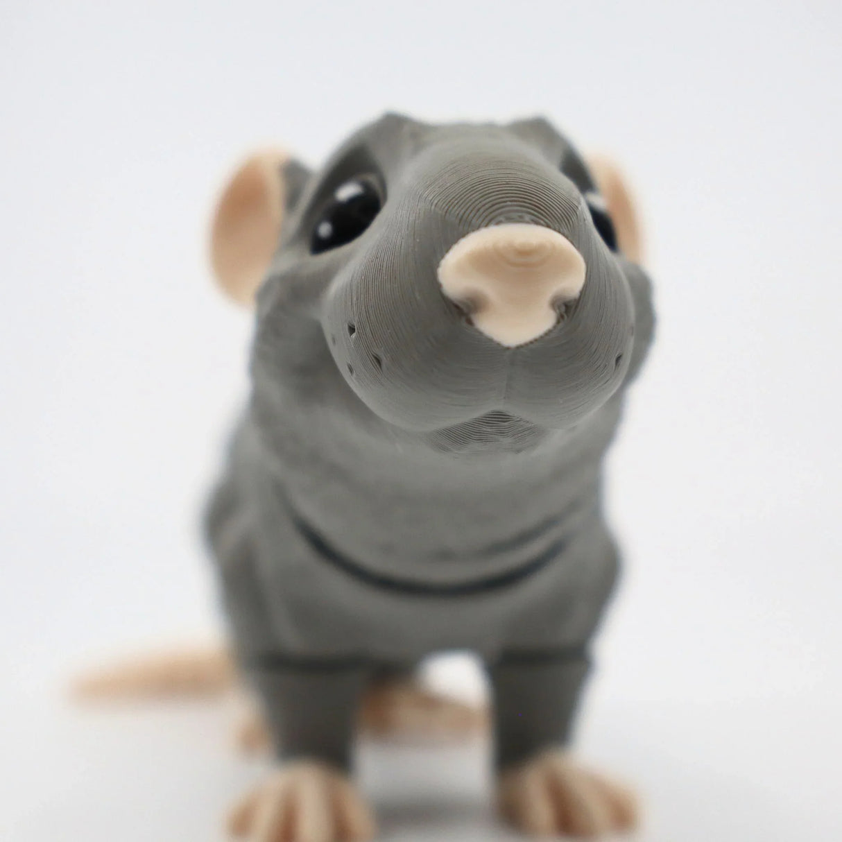 Gray 3D printed rat sensory toy with big eyes and detailed texture on a white background