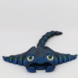 Blue 3D printed stingray sensory toy with green eyes, textured body, and flexible tail