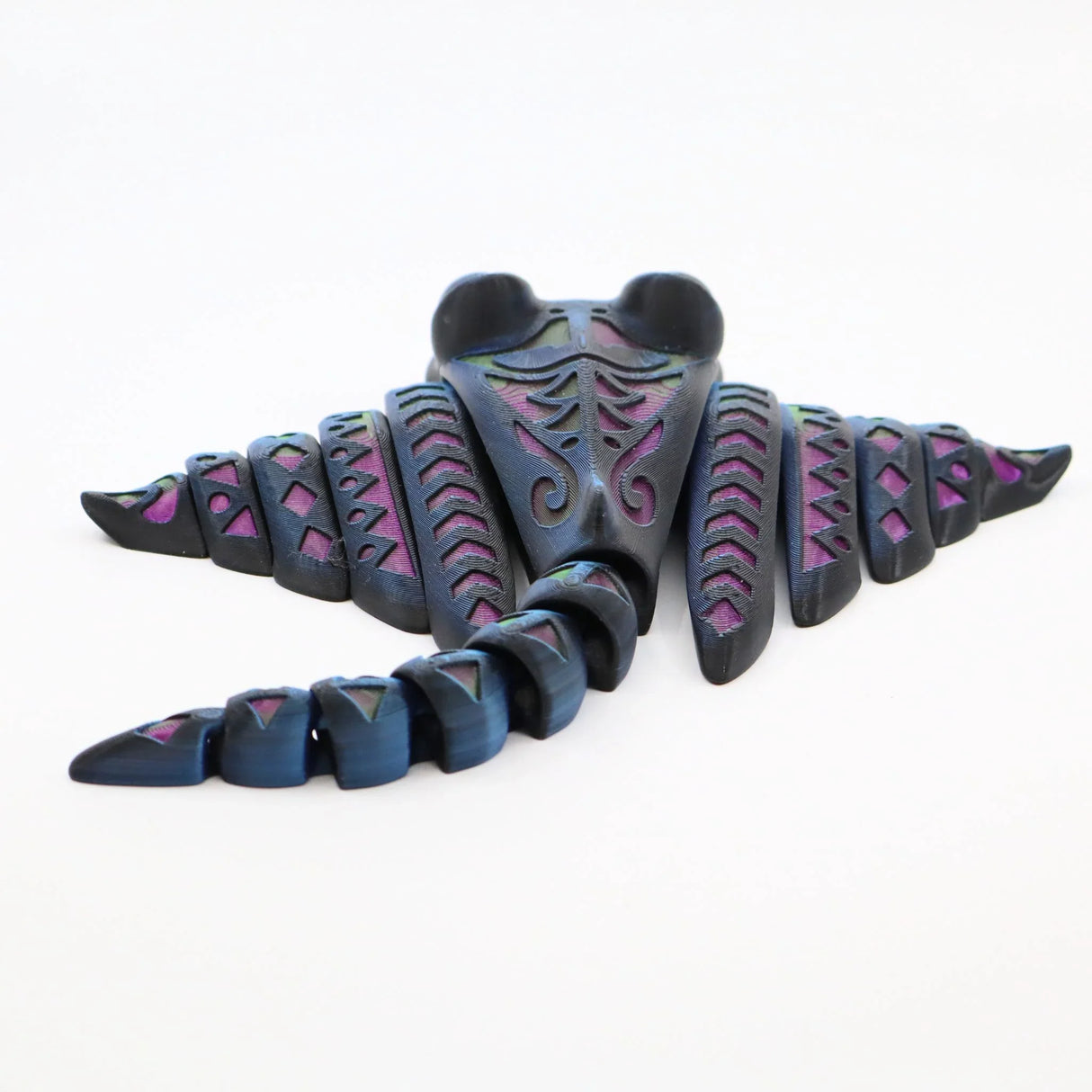 Colorful 3D printed sensory stingray fidget toy with articulated tail on white background